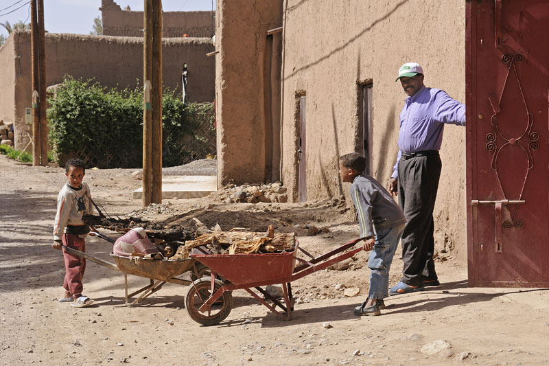 Boys with wheelbarrows in palmeraie of Skoura