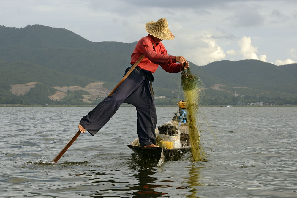 Fisherman using unique leg rowing technique
