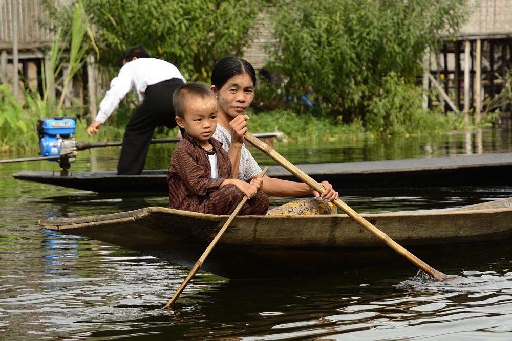 Woman and boy using water for transportation