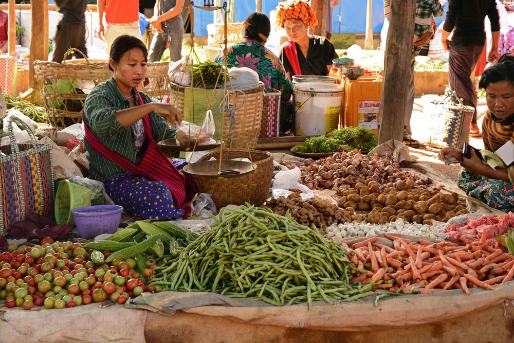 Woman weighing produce on balance scale