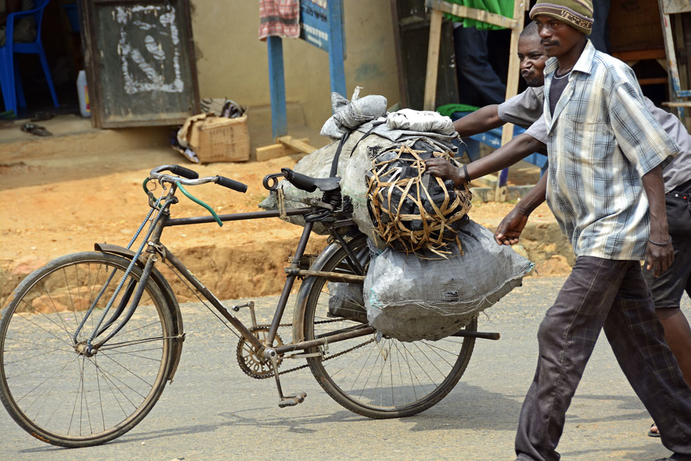 Pushing loaded bicycles is a common way to transport goods